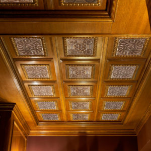05-Questo-esempio-propone-la-personalizzazione-su-misura-del-soffitto-in-legno-a-boiserie-decorato-con-formella-in-metallo-plurisoggetto